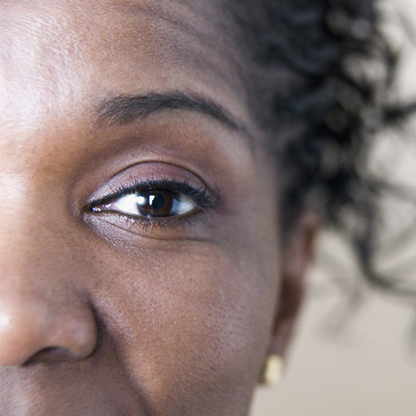 A close up of a woman's eye shows the size of her pupils.